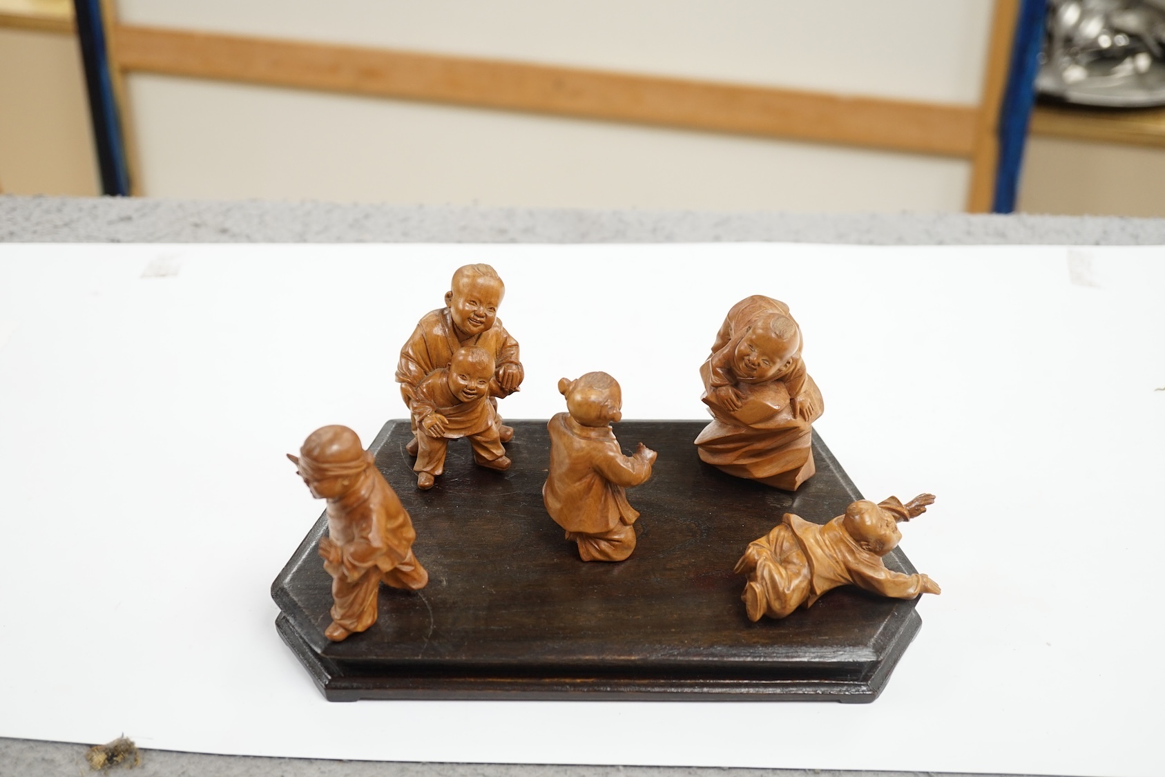 A set five Chinese carved boxwood figures of children playing Blind man’s Buff, Republic period, 23cm wide. Condition - good